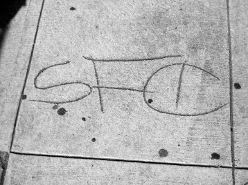 Sidewalk graffiti on San Bruno Avenue, San Francisco. "SFC" stands for "Sucka Free City."
